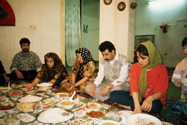 An Iranian Family Eating A Meal