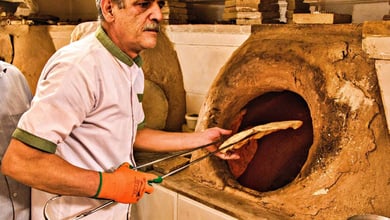 18 Popular Types Of Iranian Bread You Must Try 2 A Skilled Baker Prepares Fresh Bread In His Workshop At Yazd Bazaar, Located In The Historic City Of Yazd, Iran.