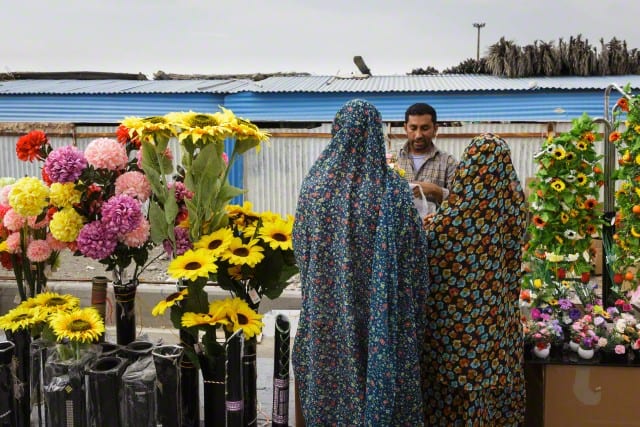 Vendor And Women In Bright Hijab At The Thursday Market Or 'Panjshambe Bazar', Minab, Southern Iran