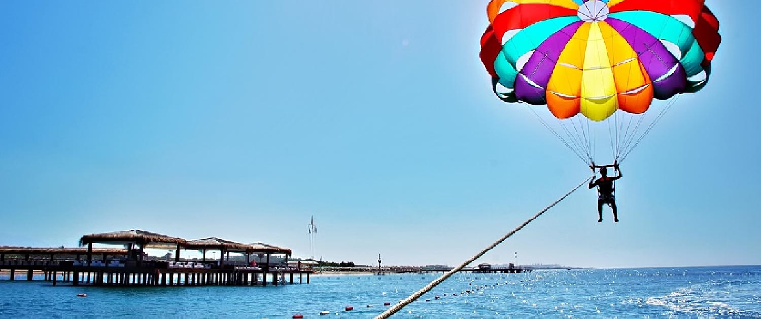 A person flying a parachute over water