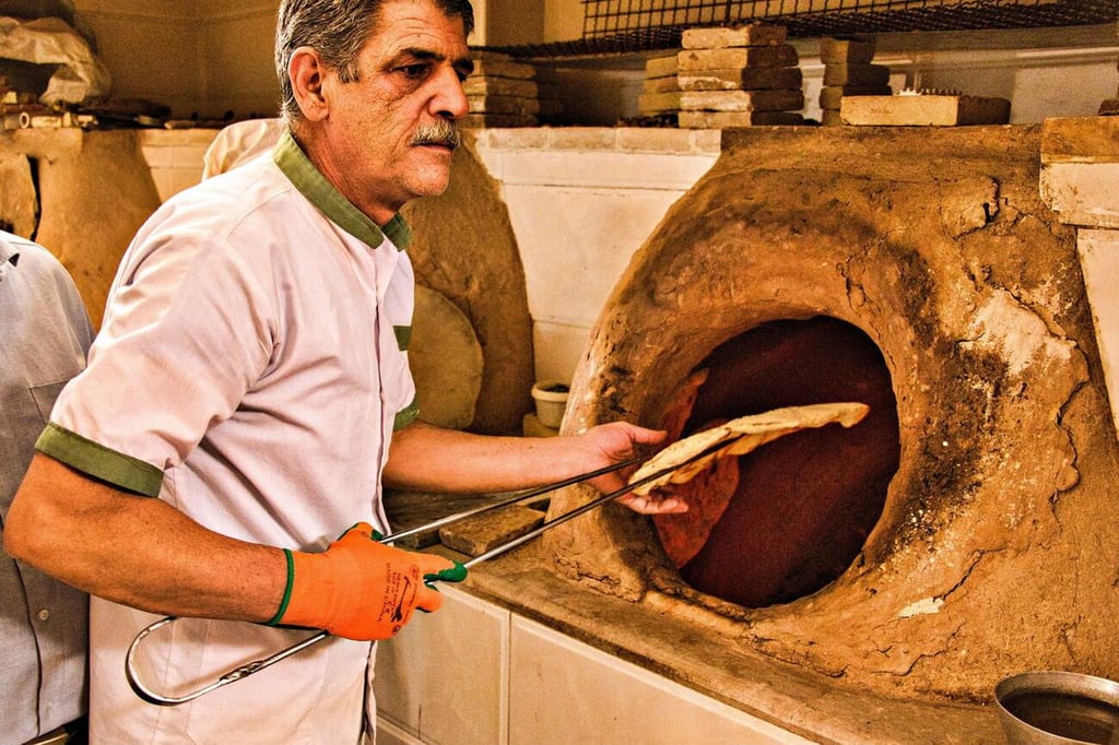 Marco Polo In Iran: A Merchant’s Path Through History 10 A Baker At Work In Yazd Bazaar, Iran, A Unesco World Heritage Site Known For Its Traditional Craftsmanship And Rich History.