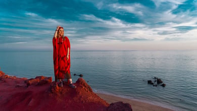 The Persian Gulf: History’s Irrefutable Name 33 A Young Iranian Woman Stands On The Red Cliffs Of Hormuz Island, Where Vivid Earth Meets The Calm Waters Of The Persian Gulf.