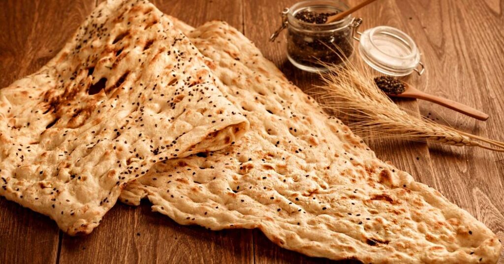 18 Popular Types Of Iranian Bread You Must Try 5 Traditional Sangak Bread Baked On Hot Stones, Known For Its Rustic Texture And Mild Sour Flavor, A Healthy Iranian Bread Rich In Nutrients.