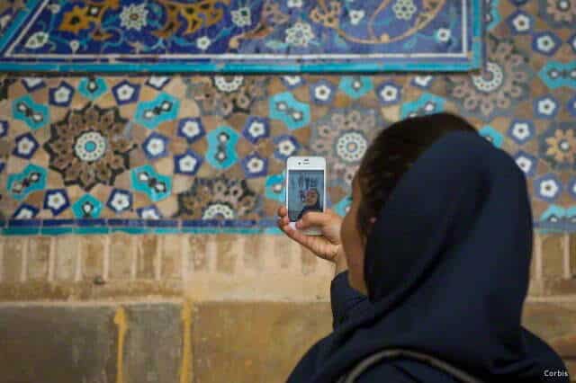 Iran, Isfahan Province, Isfahan, iranian tourist taking picture with her mobile phone